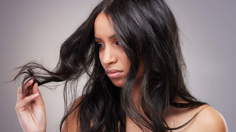 Woman looking at split ends