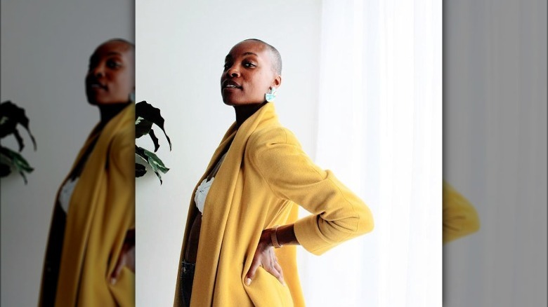 black woman yellow blazer hand on hips