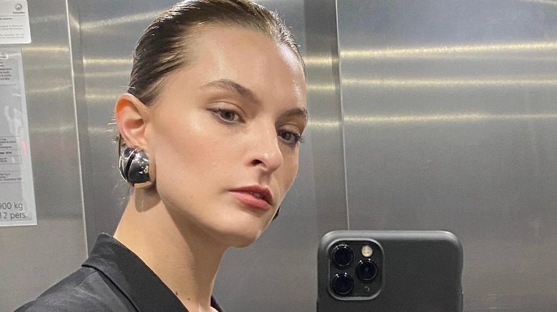 woman pulled back hair silver blob earrings