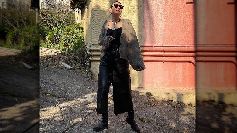 woman in large brown cardigan black sunglasses