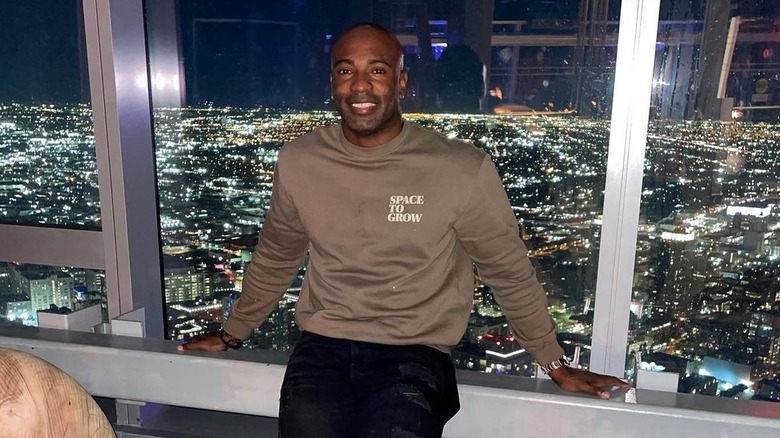 Gil Cuero posing in front of downtown Los Angeles