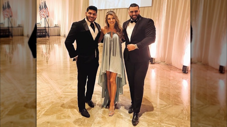 Ginger Gaetz smiling as she poses in a blue dress