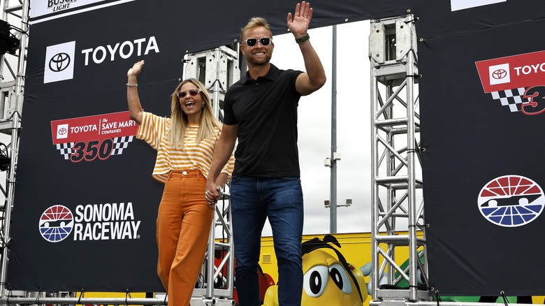 Candace Cameron Bure and Valeri Bure waving at a crowd