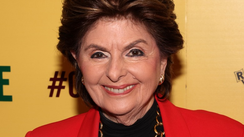 Gloria Allred smiling red jacket