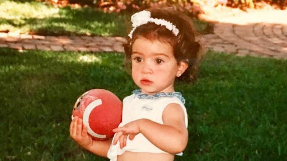 Gloria Estefan's daughter Emily Estefan as a child with a ball