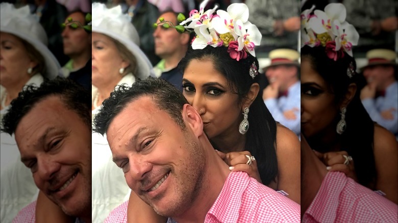 Woman with flower fascinator and man in pink