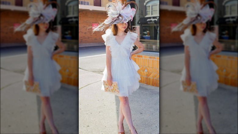 woman posing in frilly white dress