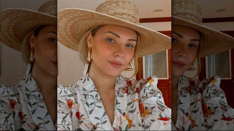 woman in floral dress and straw hat