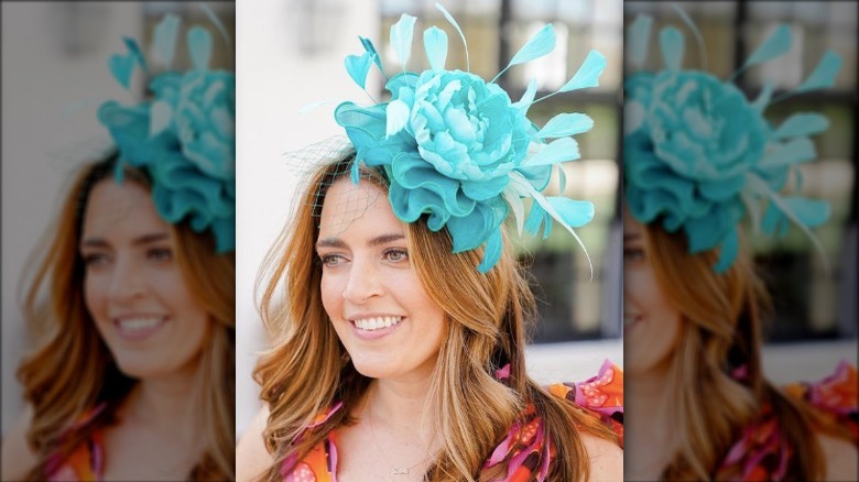 Redhead wearing a teal flower fascinator