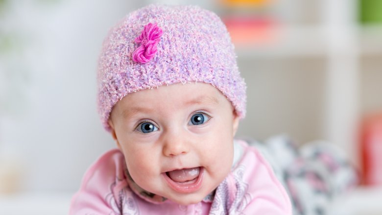 smiling baby in pink with blue eyes