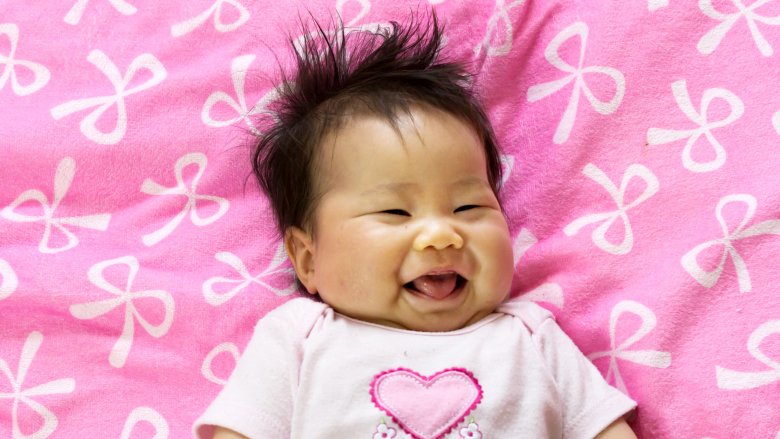 smiling baby girl with tongue out