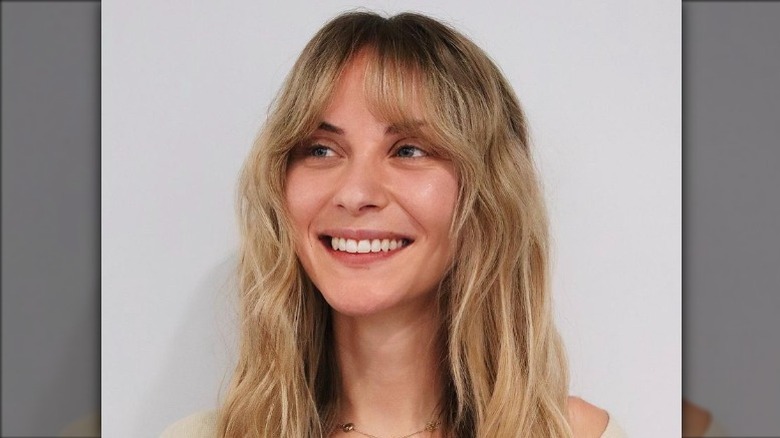 Woman with bottleneck bangs smiling