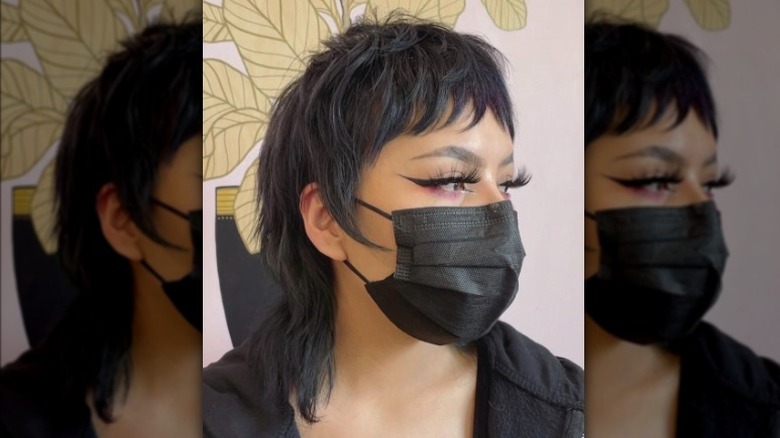 Person with mullet wearing face mask