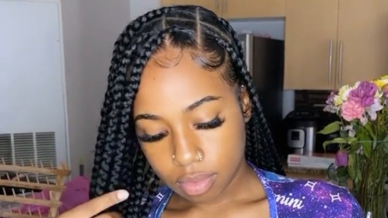 person with parted box braids