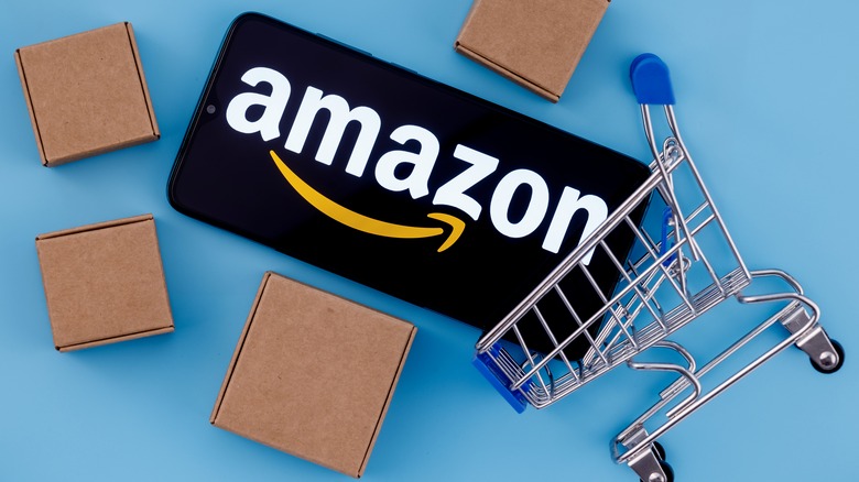 shopping cart with amazon logo and cardboard boxes