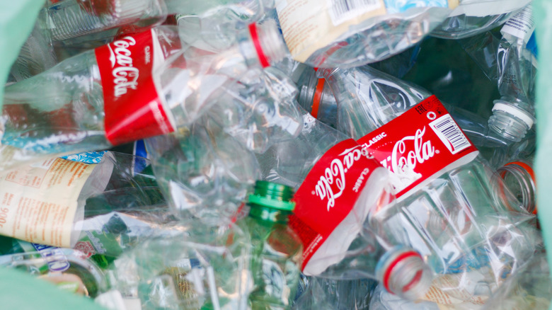 Coca-Cola bottles displayed prominently among plastic waste