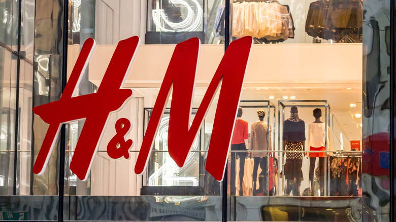 H&M storefront window with mannequins visible