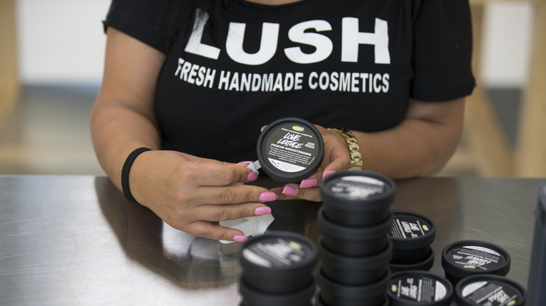 Lush cosmetics employee labeling containers