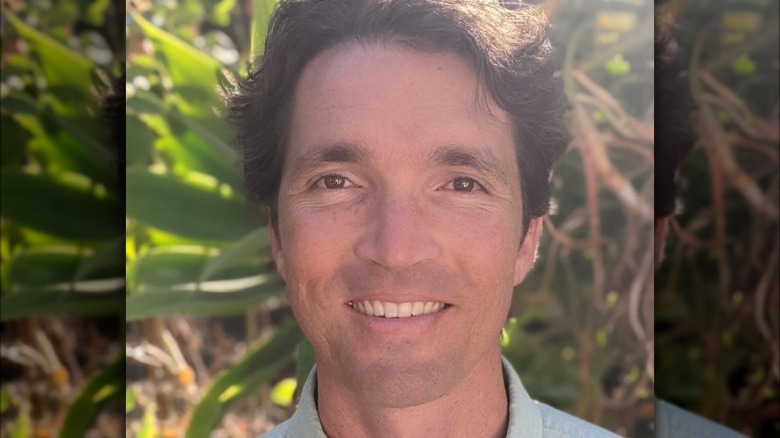 Christopher Peck in front of plants