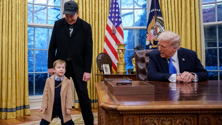 Elon Musk laughing as X Æ A-Xii makes a funny face while Donald Trump is talking