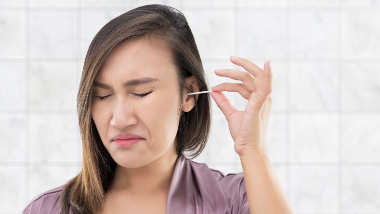 woman using a q-tip in her ear