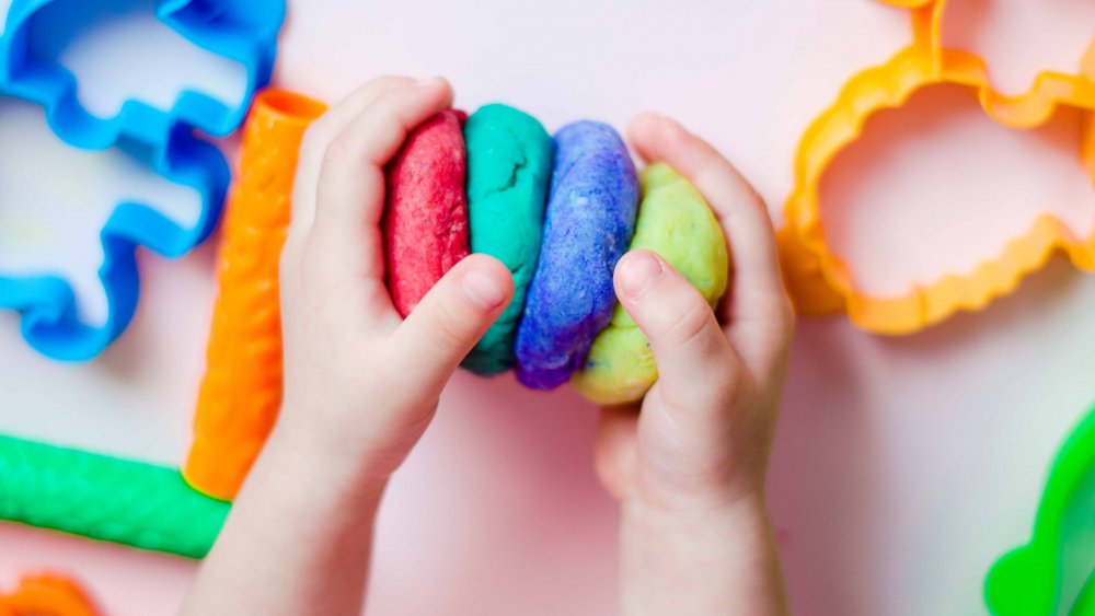 kid playing with play doh