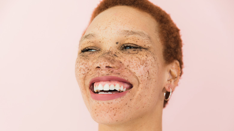 smiling woman with close-cut red hair