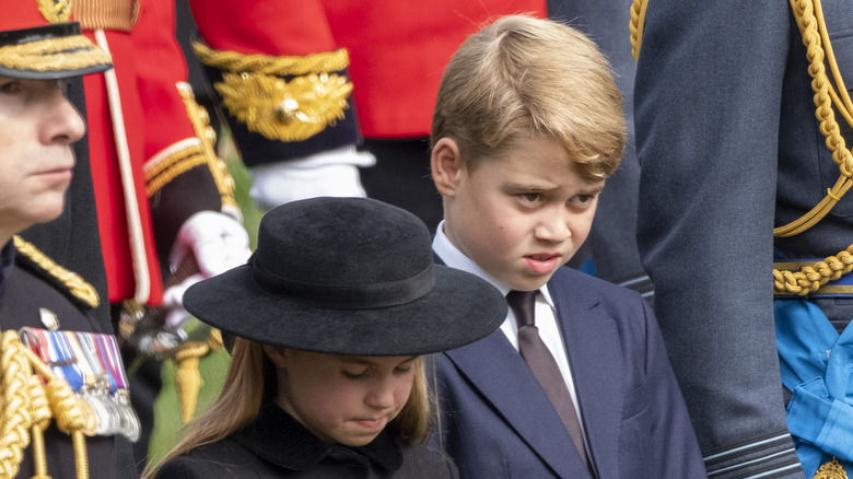 Princess Charlotte bows head next to Prince George