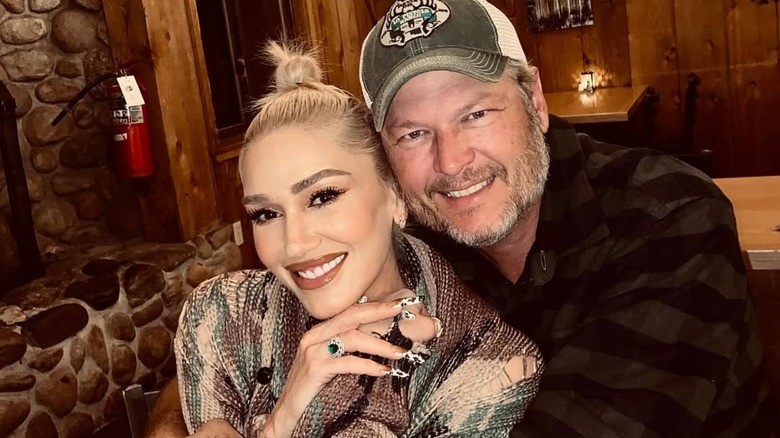 Gwen Stefani and Blake Shelton cuddling up at a restaurant