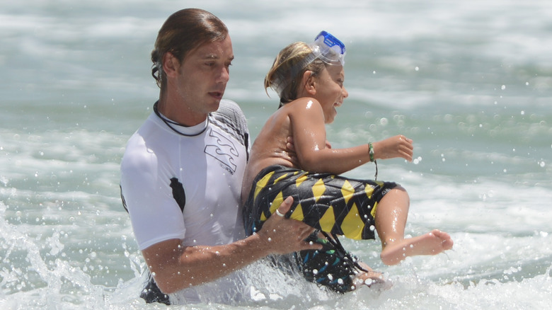 Gavin Rossdale playing in the sea with his son