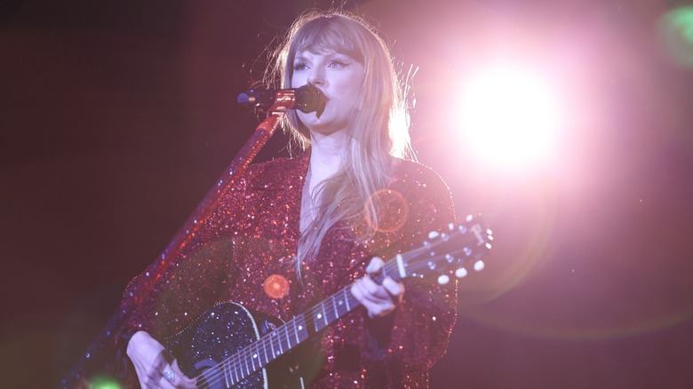 Taylor Swift singing playing guitar