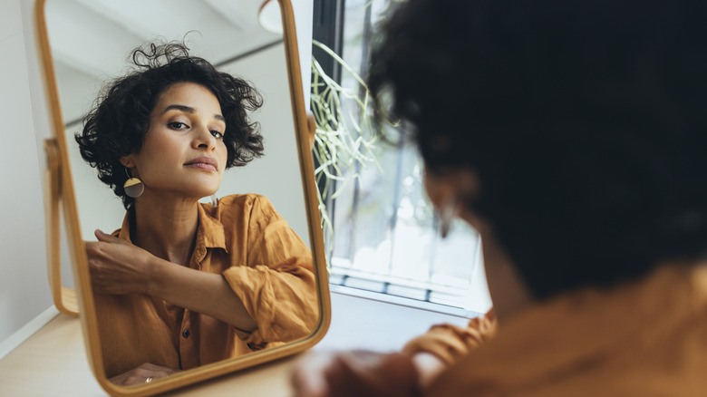 Woman looking in mirror