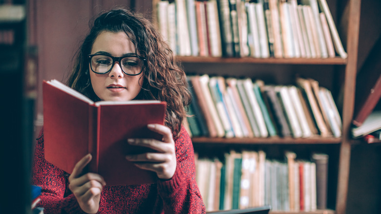 Woman reads in library