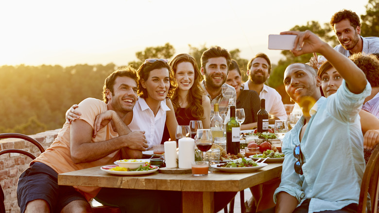 Group takes photo at dinner