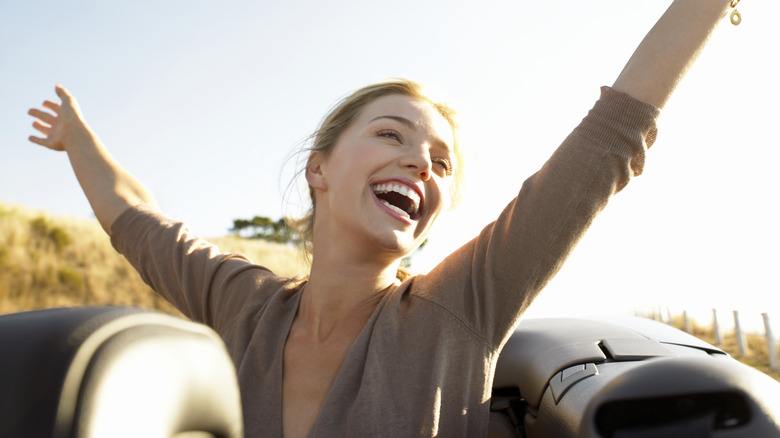 smiling woman in convertible