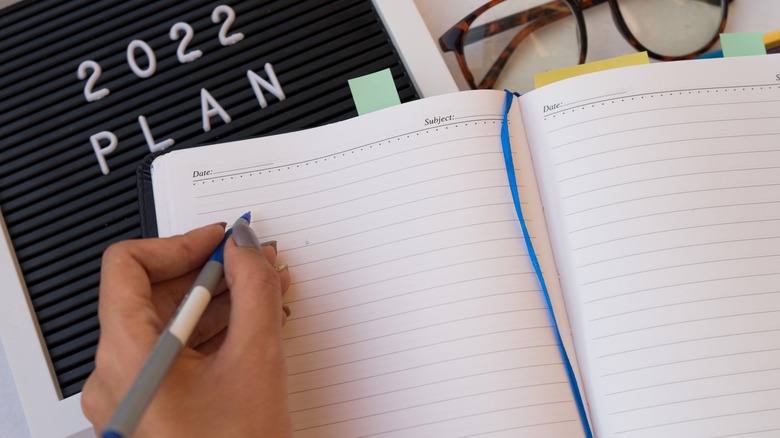 a woman writing in a journal