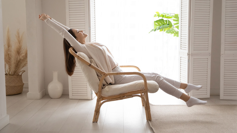 a woman stretching in a chair