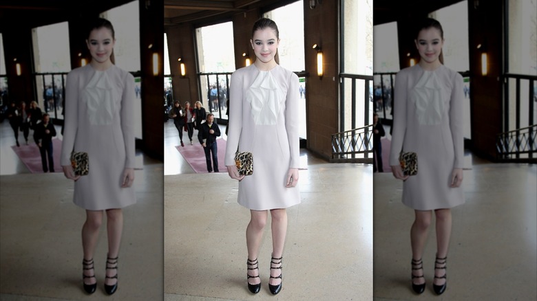 Hailee Steinfeld smiling at the Miu Miu Paris Fashion Week show in 2011