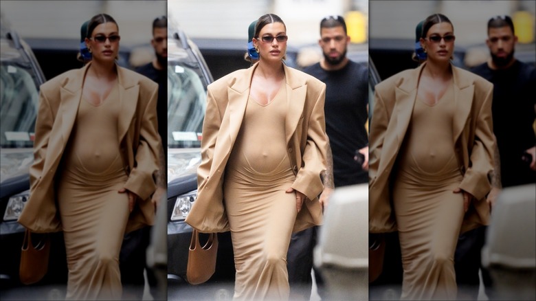 Hailey Bieber in a brown bodycon dress while pregnant