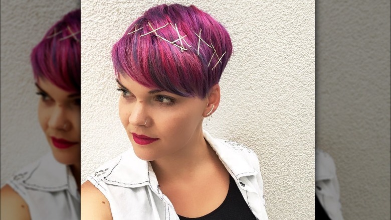 Woman with bright pink hair and bobby-pin crown