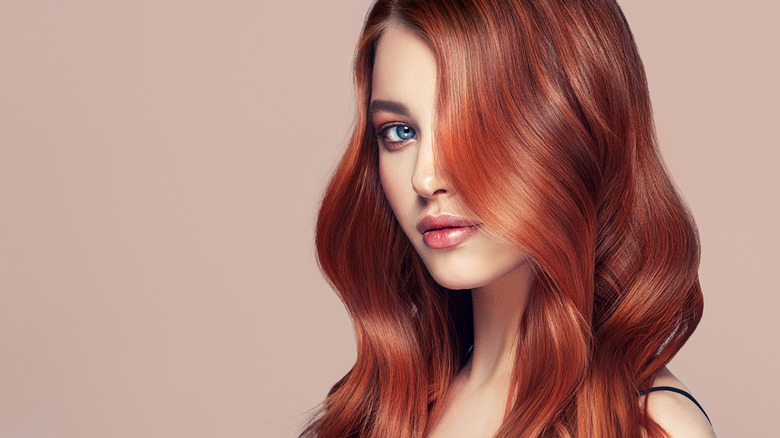 A woman with wavy red hair. 