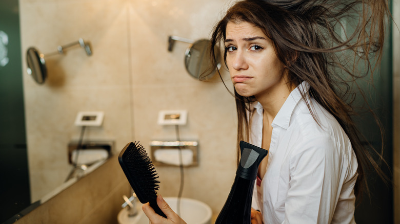 Woman using hair dryer 