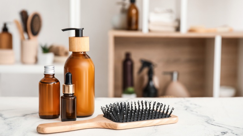 Display of cosmetic bottles with a hairbrush