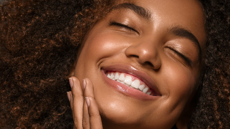 A woman with curly hair smiling