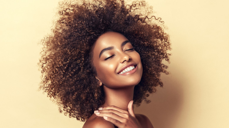 Young woman with curly hair smiling