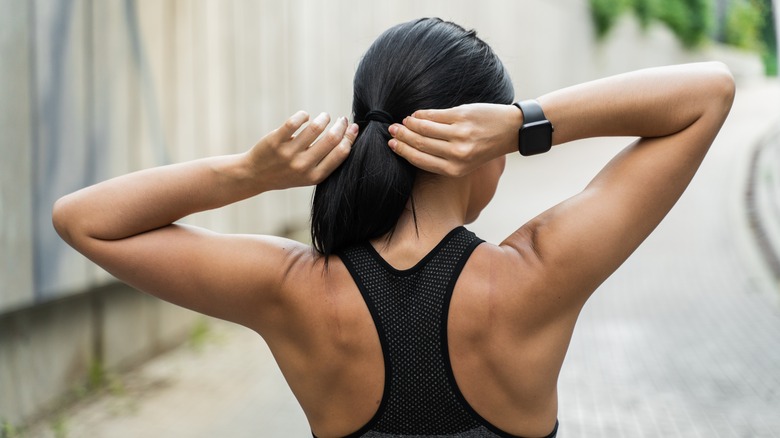 woman tightening her ponytail