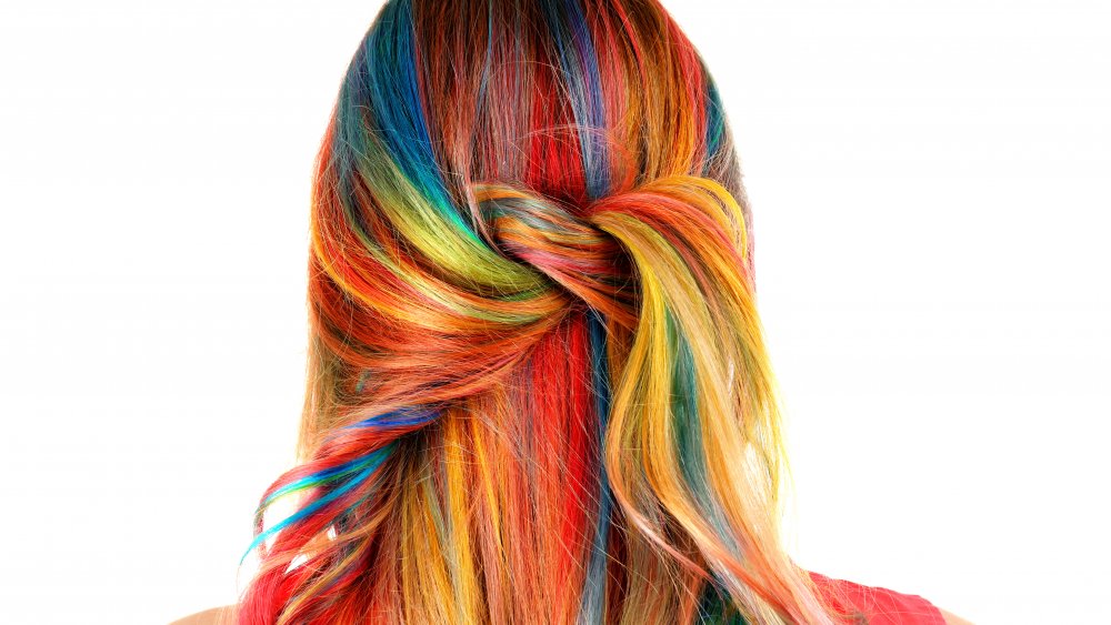A woman with multicolored rainbow hair from behind