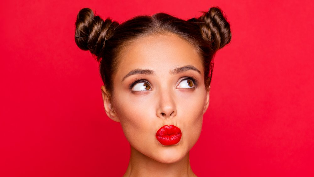 A woman with a space bun hairstyle 