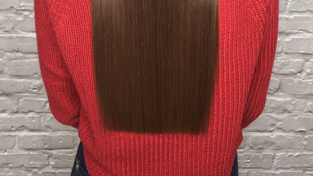 A woman's long hair with a blunt cut line