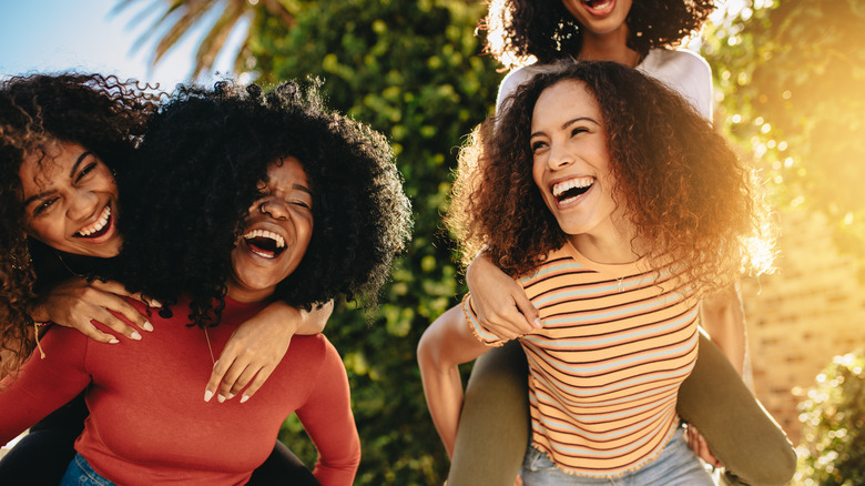 Friend group with curly hair smiling